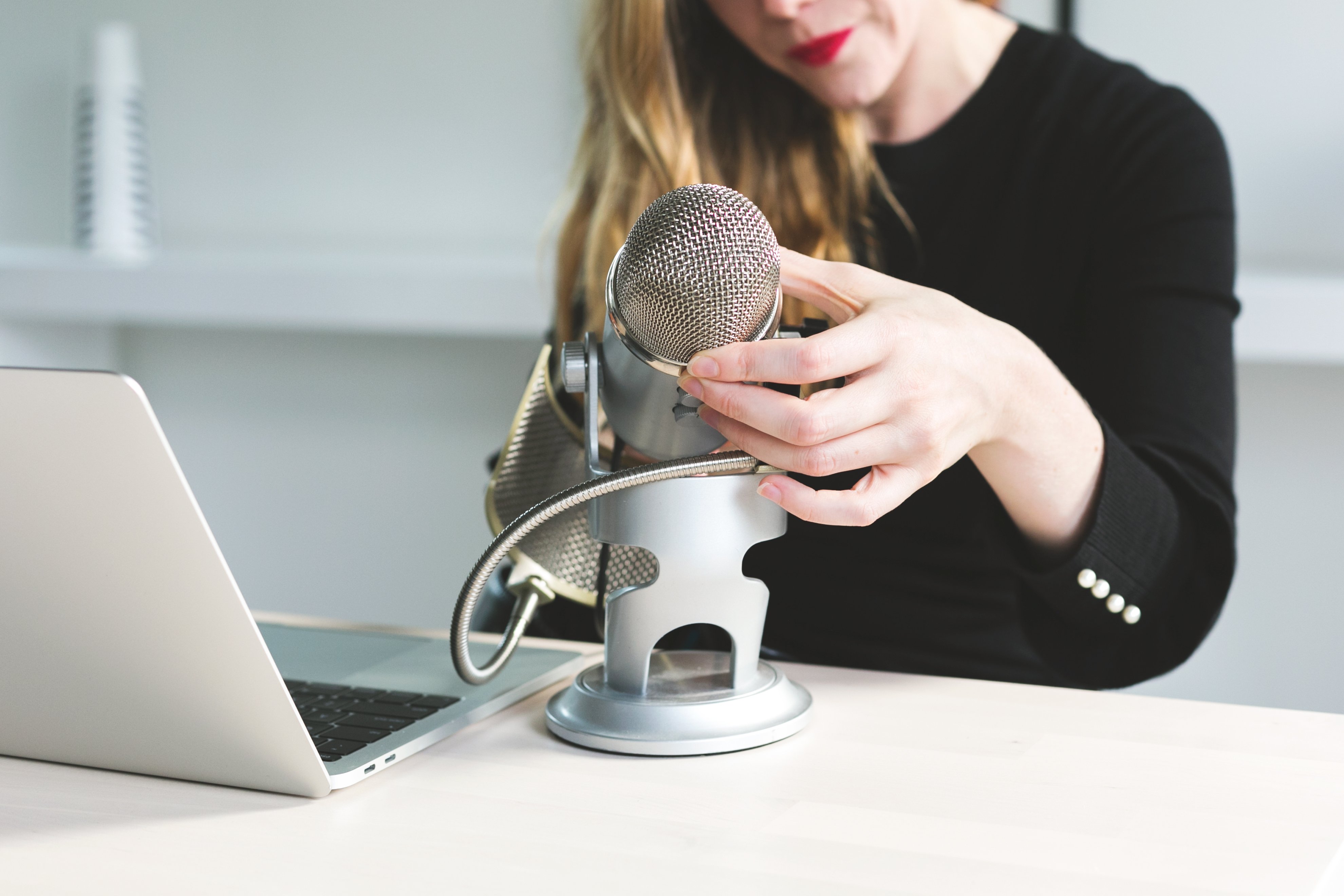 woman-adjusts-microphone